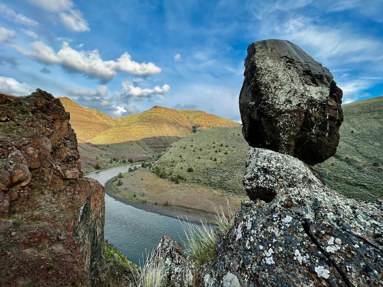 A balanced boulder above a bend in the river.