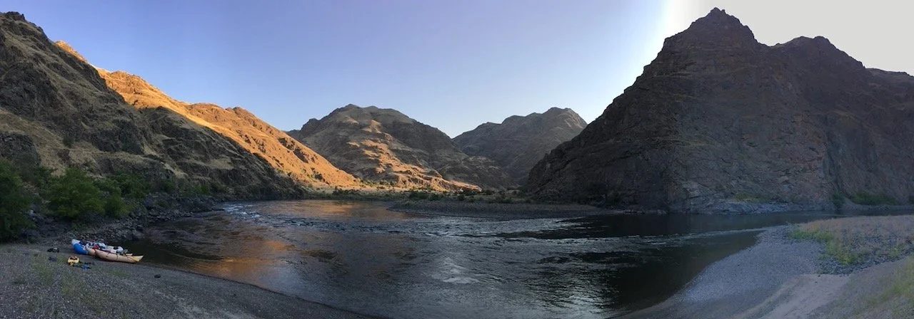 A wide river canyon at golden hour.
